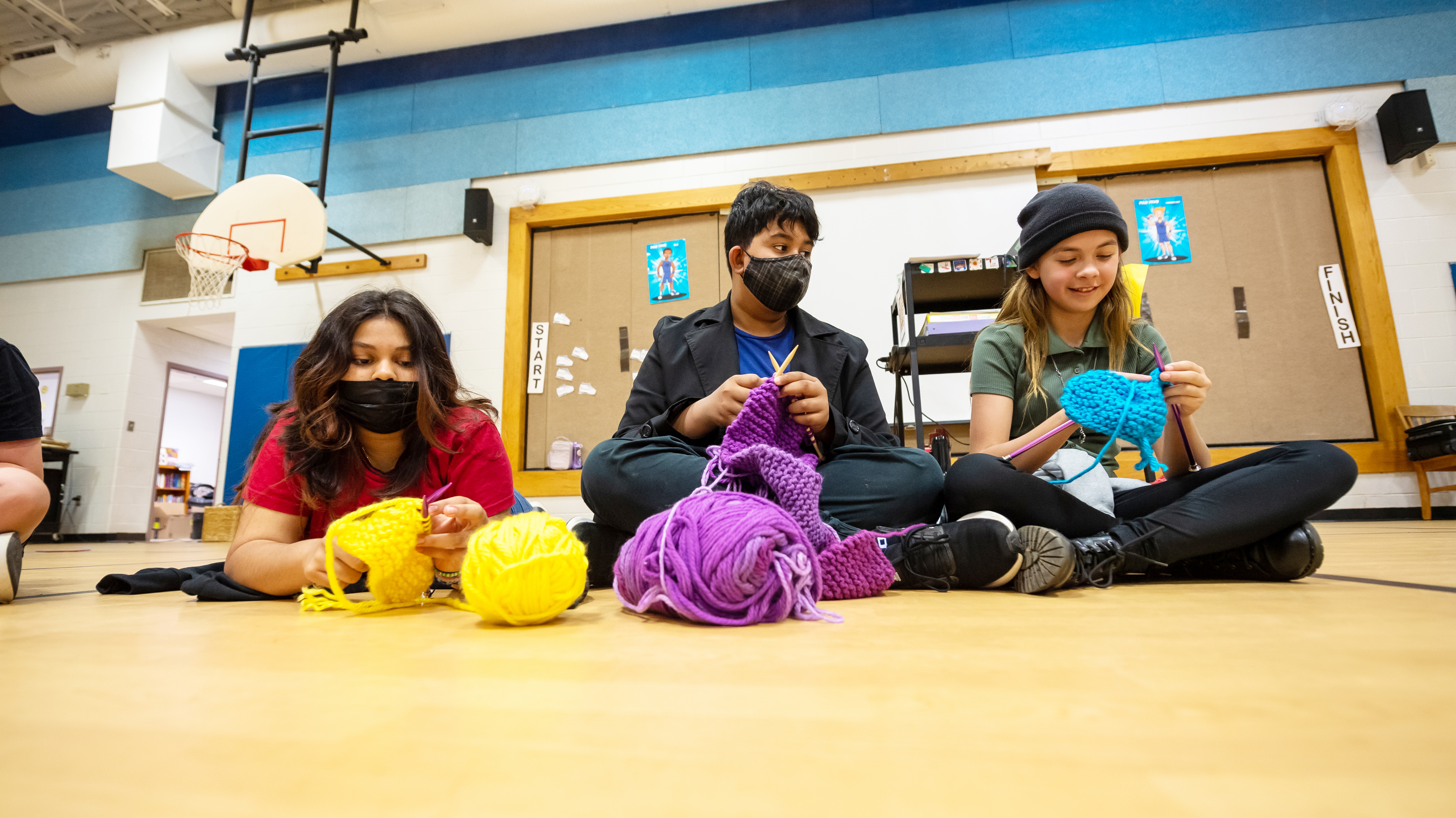 Sixth-graders at Little Run Elementary School meet to knit during their lunch period.
