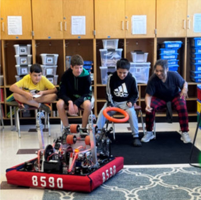 Students playing with a robot